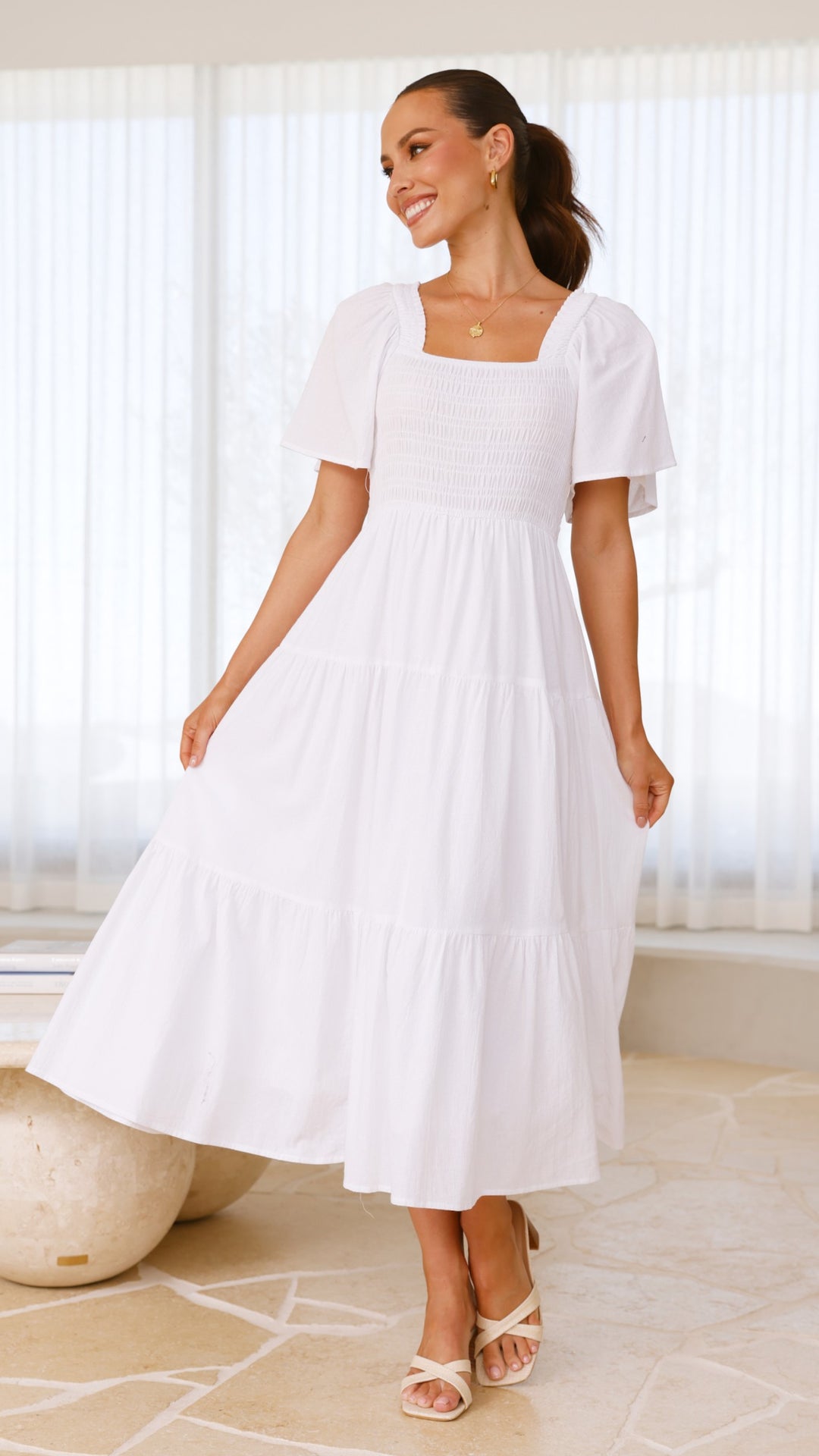 White midi dress with smocked front and back, puff sleeves, and tiered skirt