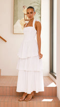 White crepe tiered maxi dress with halter neckline and back tie-up bow