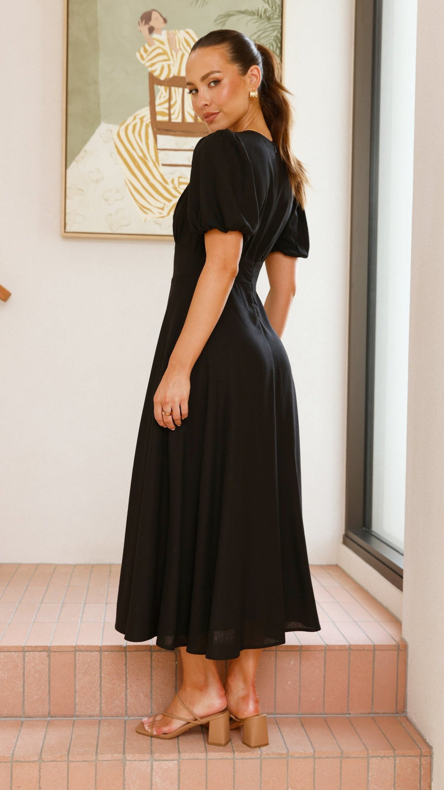 black linen puff sleeve maxi dress with a deep V neckline and flared skirt