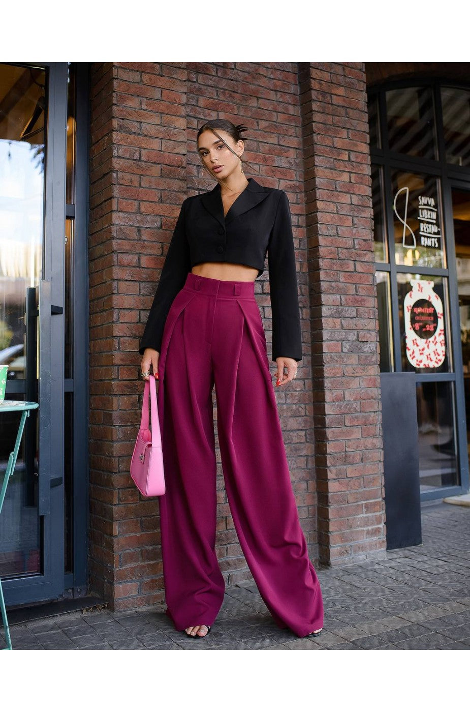 Model wearing cropped black banana crepe blazer top