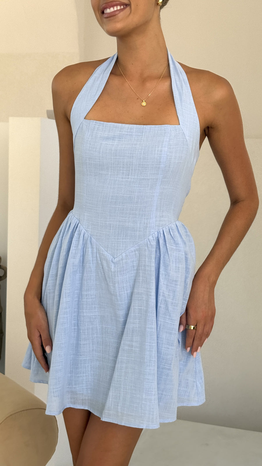 Light blue linen halter mini dress with flared skirt and smocked back