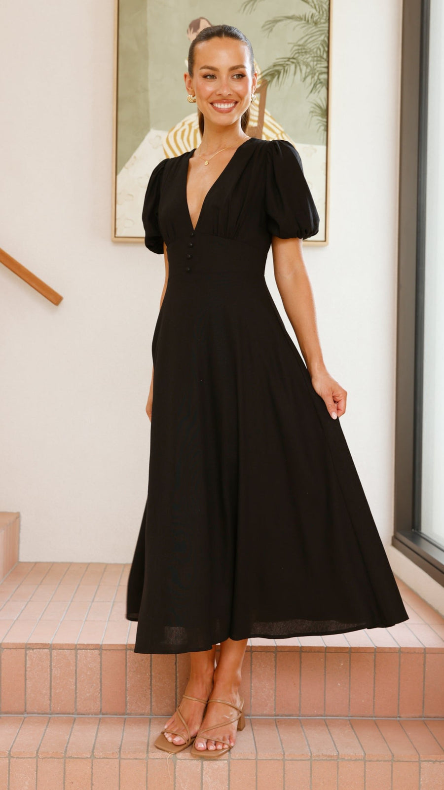 black linen puff sleeve maxi dress with a deep V neckline and flared skirt