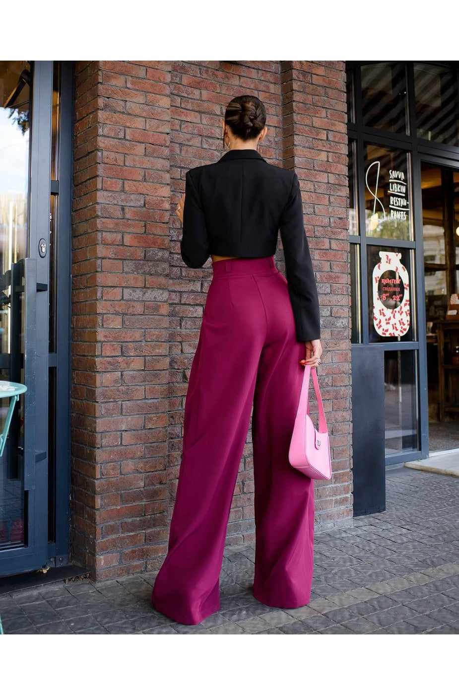 Model wearing cropped black banana crepe blazer top