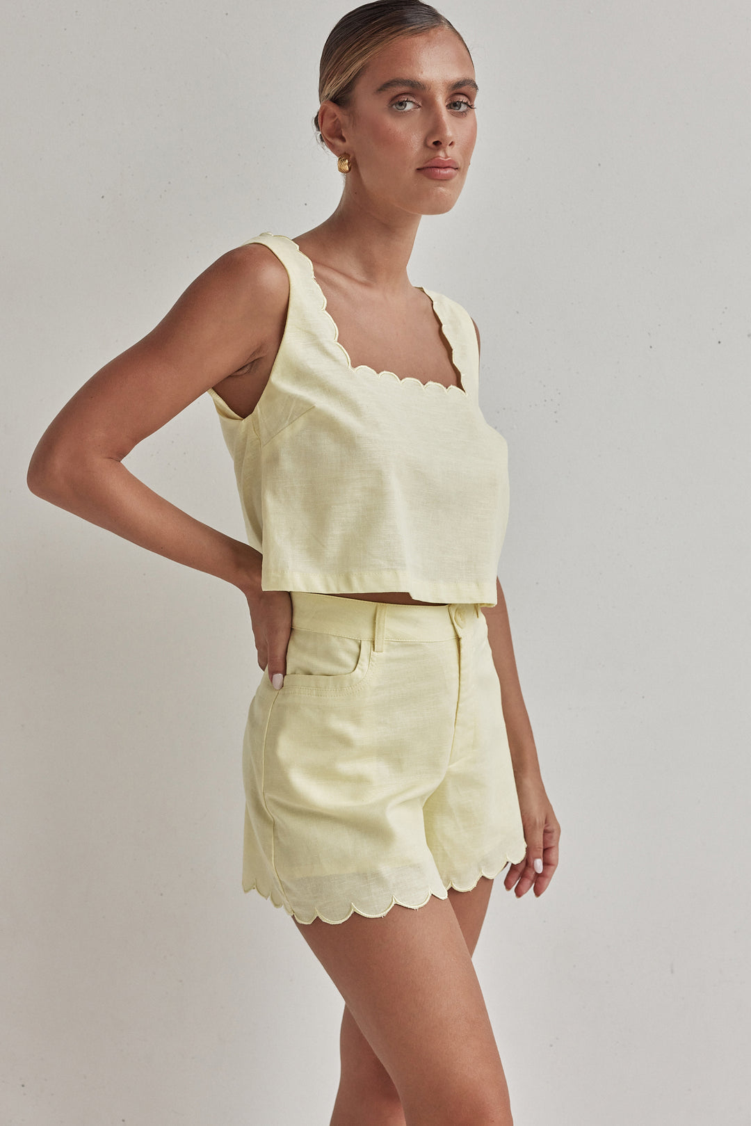 Butter yellow linen shorts for women with scalloped hem and high waist