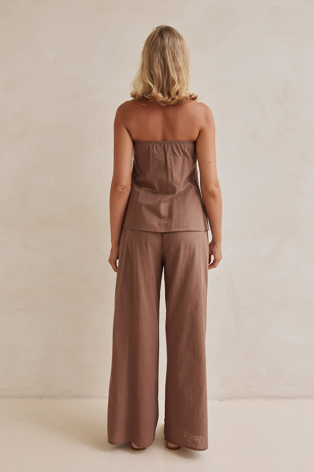 Brown linen co-ord set with strapless pleated top and wide-leg pants