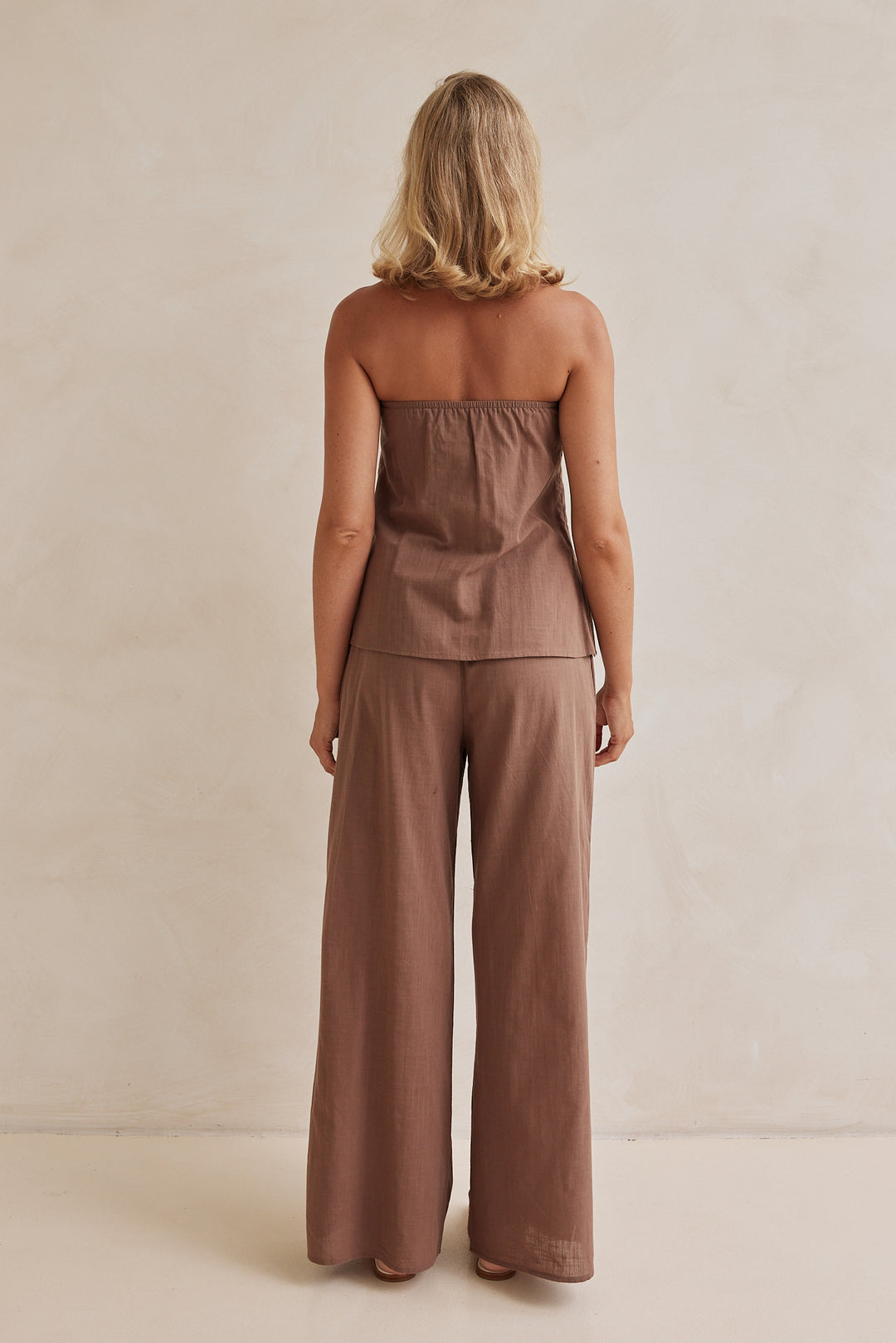 Brown linen co-ord set with strapless pleated top and wide-leg pants