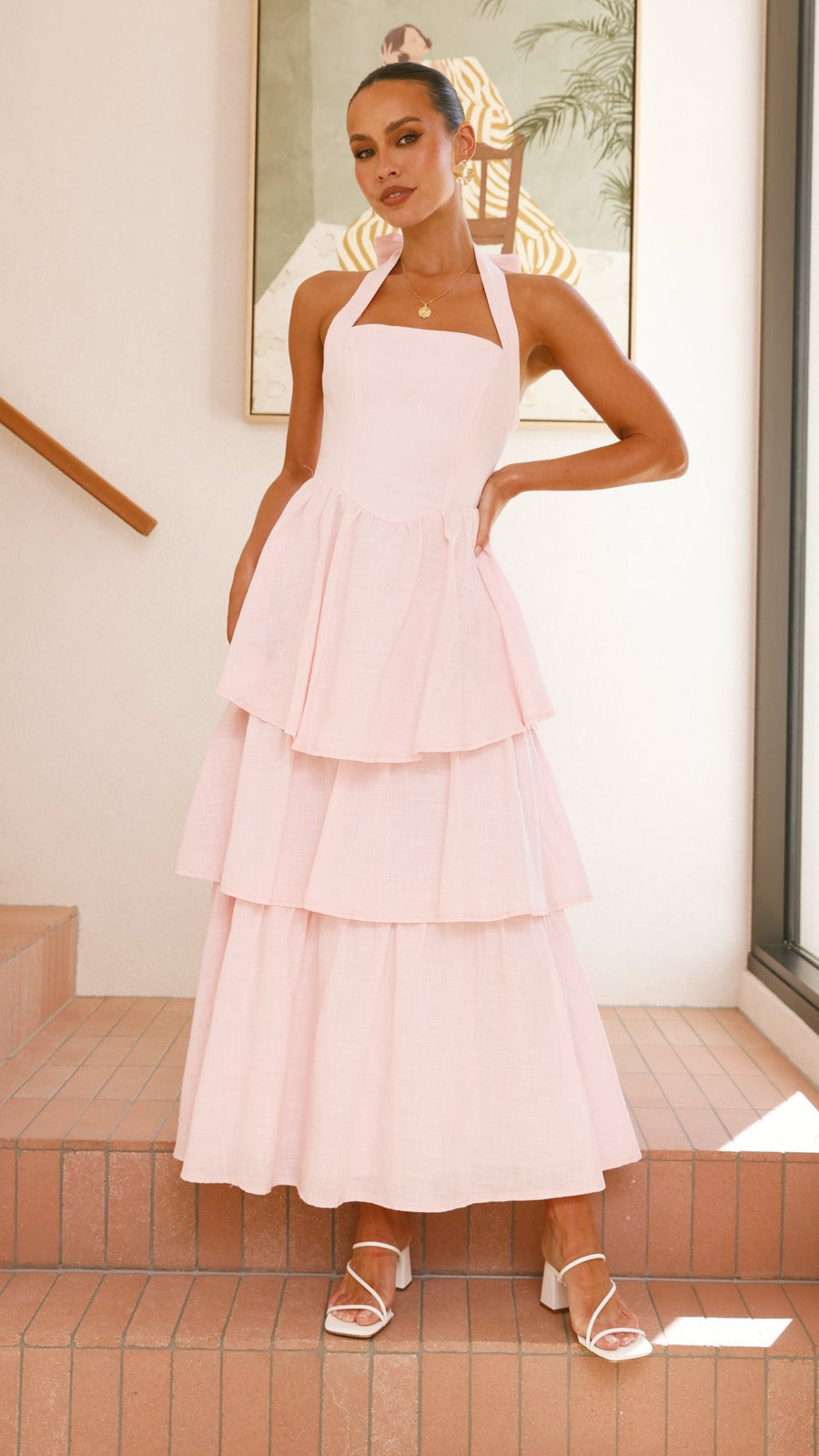 Pink crepe tiered maxi dress with halter neckline and tie-up bow back