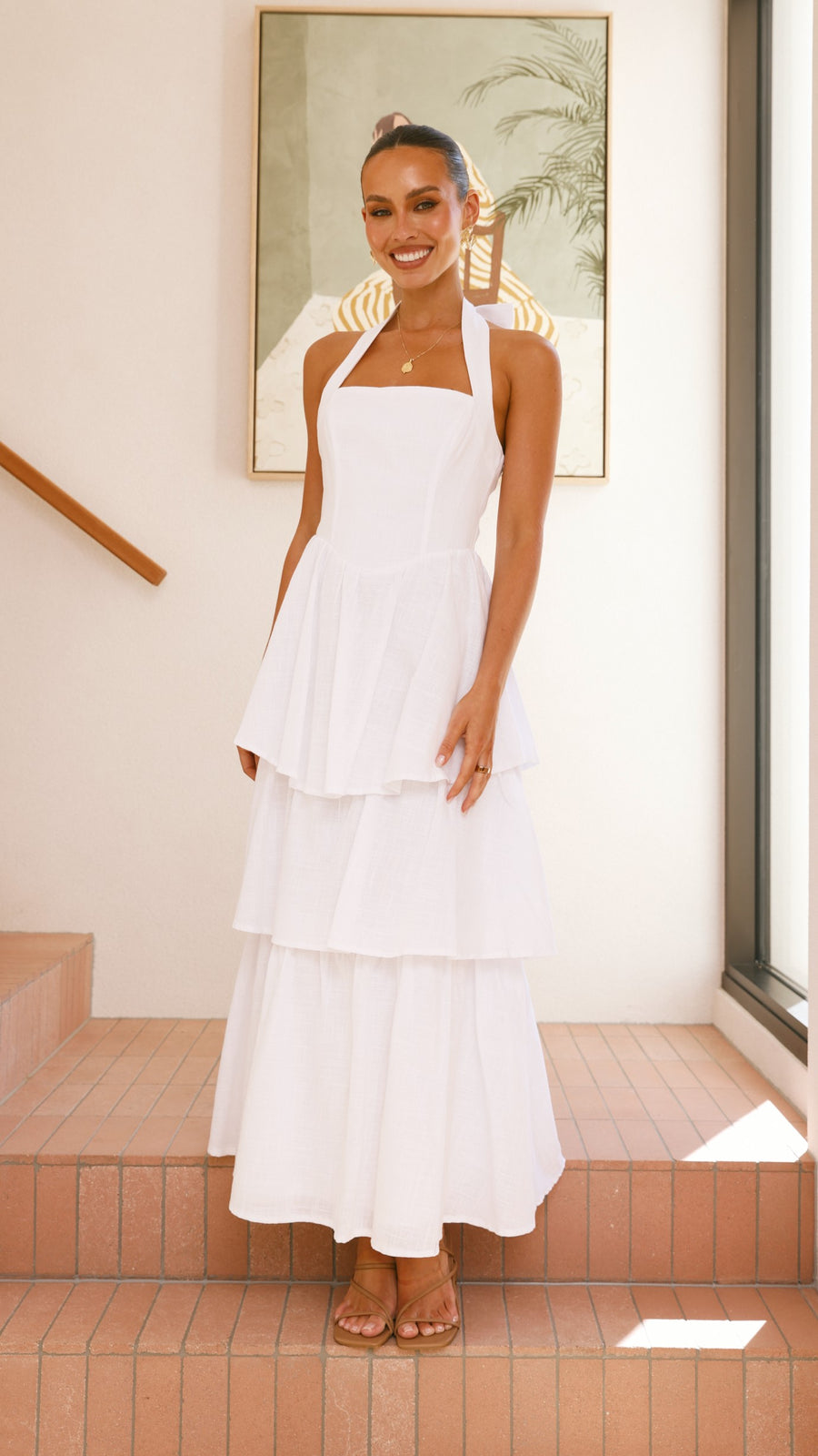 White crepe tiered maxi dress with halter neckline and back tie-up bow