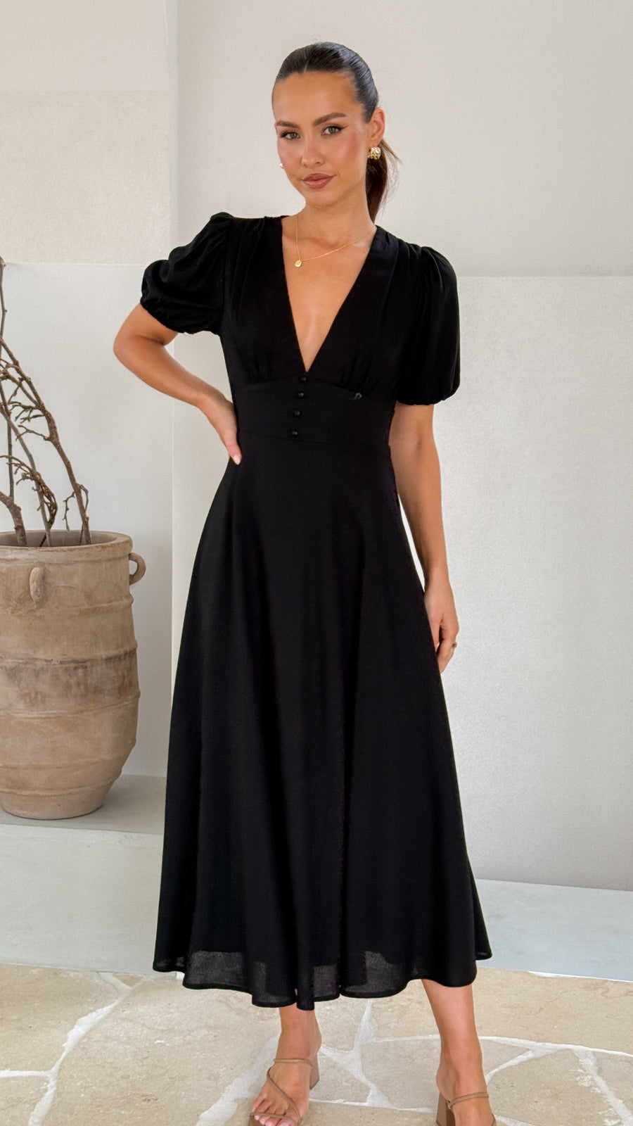 black linen puff sleeve maxi dress with a deep V neckline and flared skirt