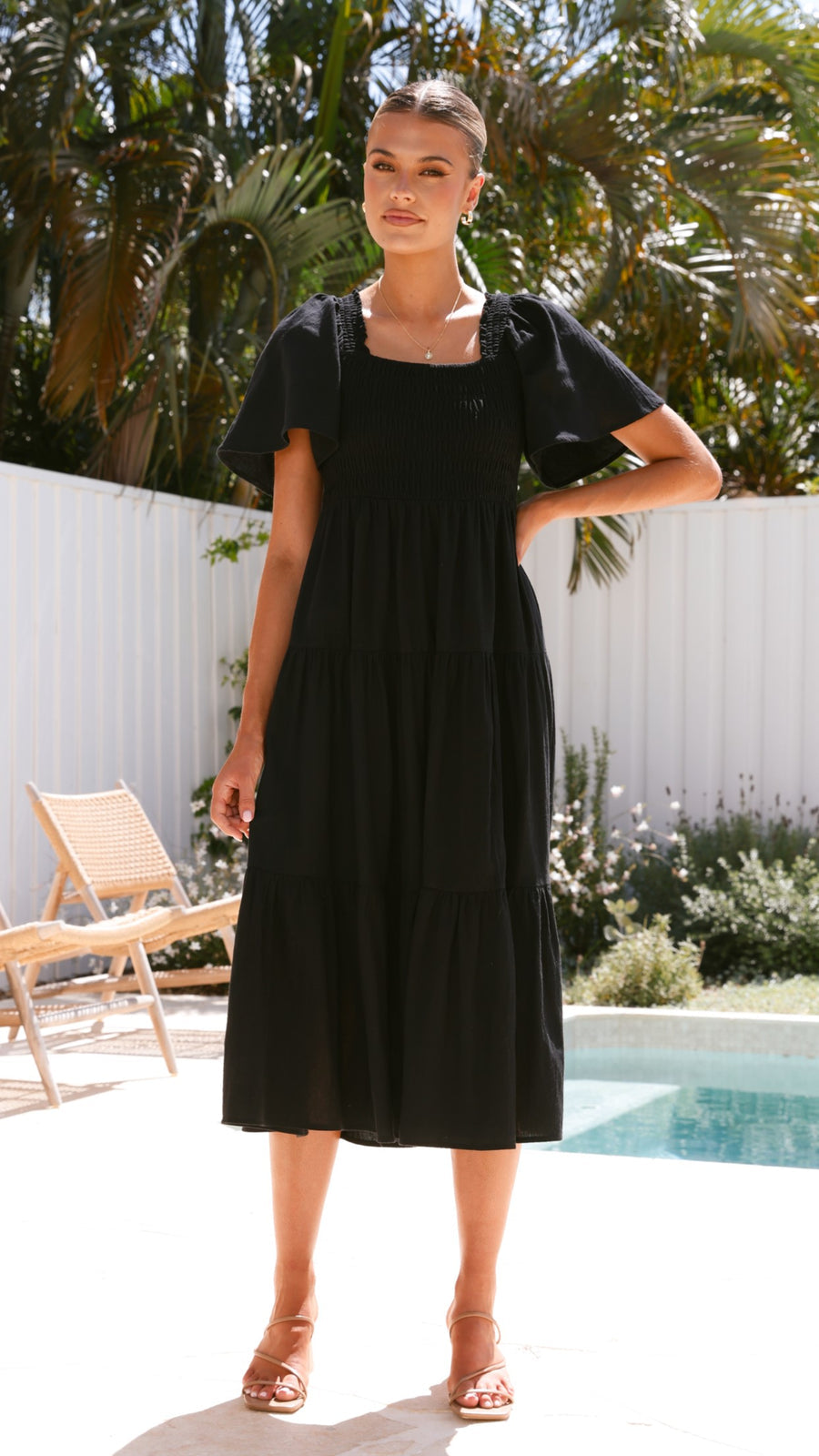Black linen maxi dress with smocked bodice and flutter sleeves
