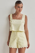 Butter yellow linen crop top with scalloped hem and sleeveless design