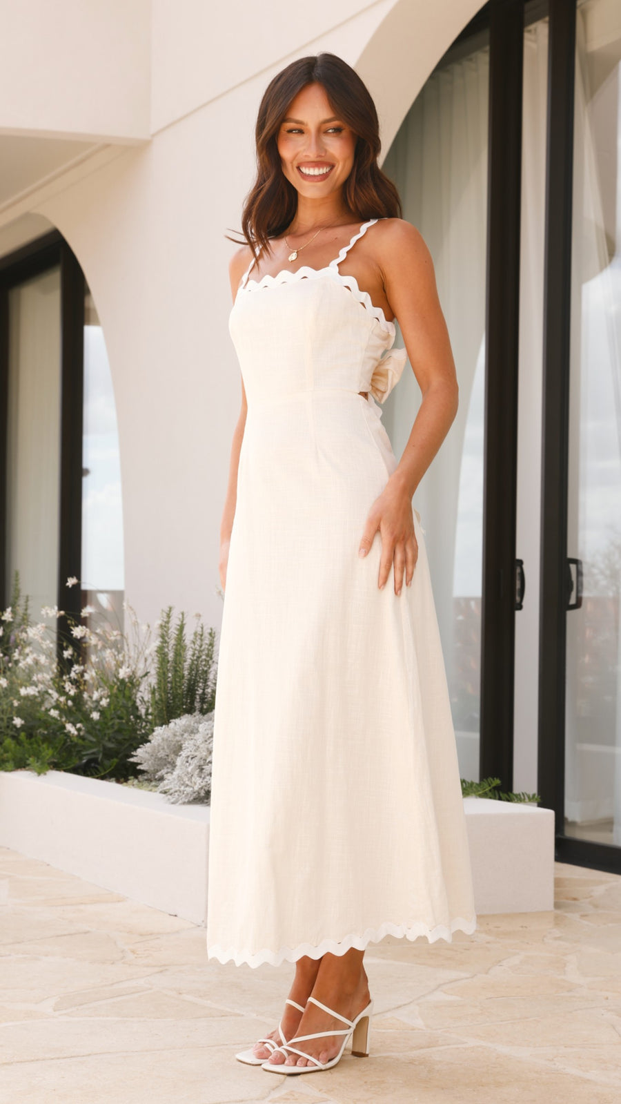 Ivory linen midi dress with scalloped straps and oversized back bow