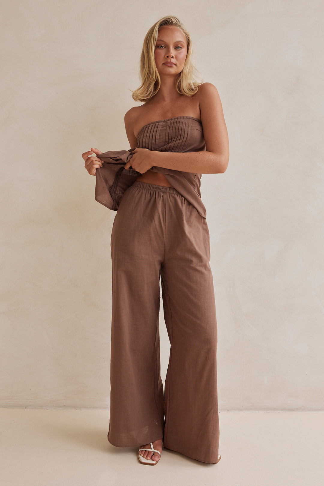 Brown linen co-ord set with strapless pleated top and wide-leg pants
