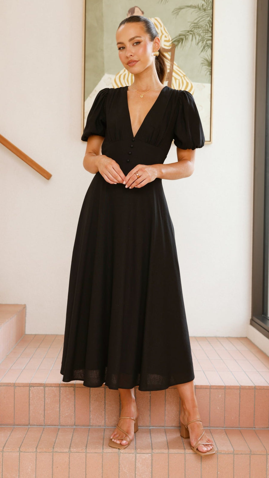 black linen puff sleeve maxi dress with a deep V neckline and flared skirt