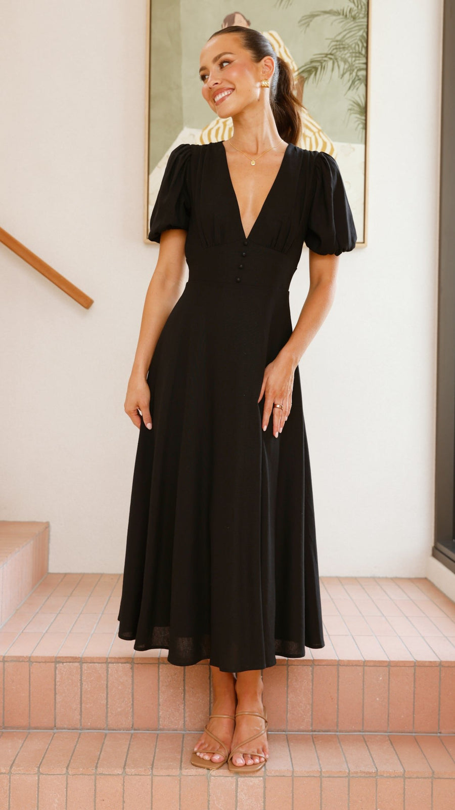 black linen puff sleeve maxi dress with a deep V neckline and flared skirt