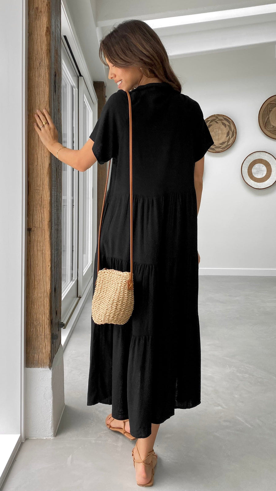 Black linen midi dress with short sleeves, tiered skirt, and button-down front