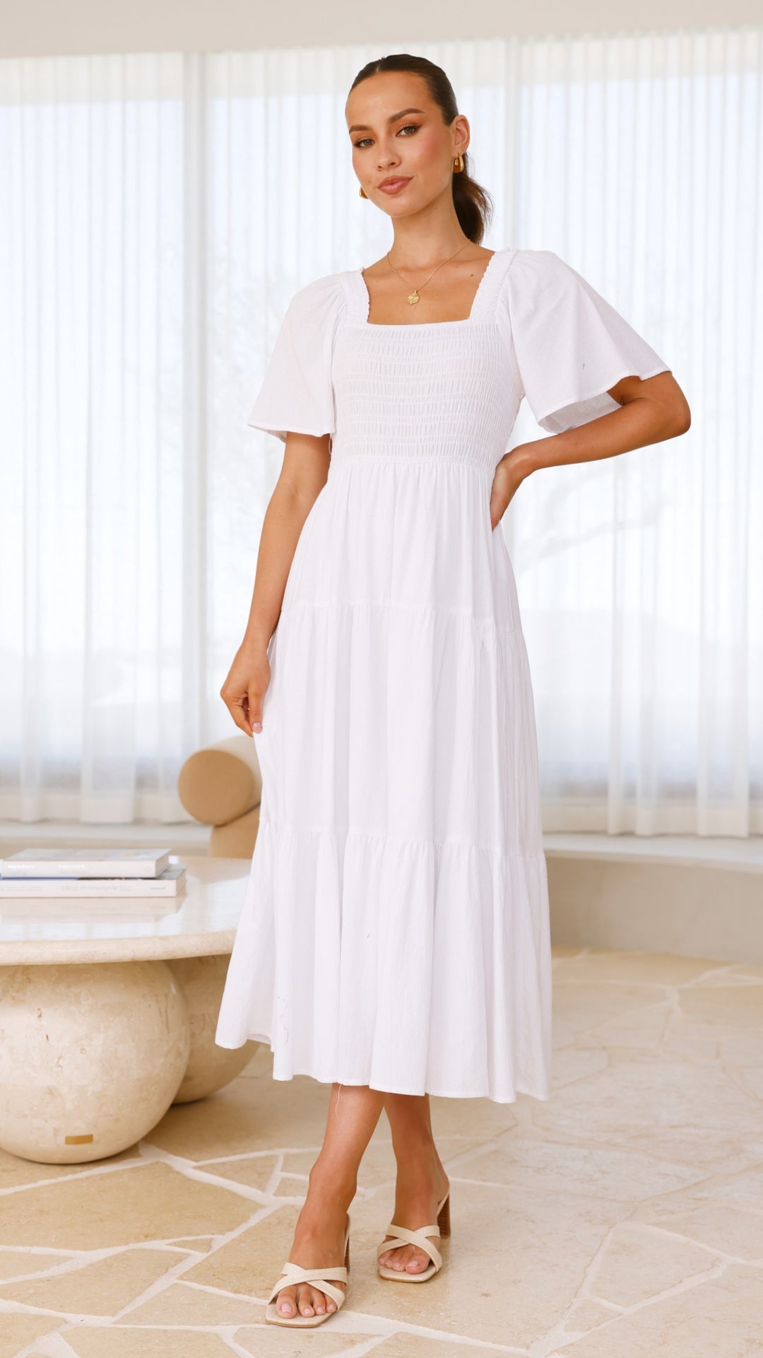 White midi dress with smocked front and back, puff sleeves, and tiered skirt